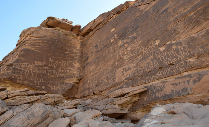 Inscriptions in Ancient South Arabian script, engraved on a rocky spur near Ḥimā, north of Najrān (Saudi Arabia). The wall also features the drawings of musicians and cattle.