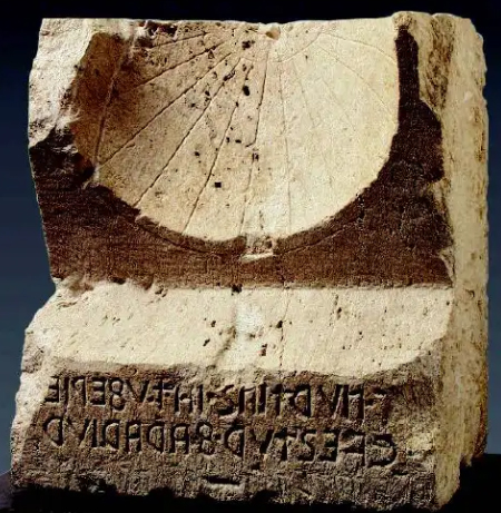 Limestone sundial from Bevagna (ancient Mevania), site Madonna del Core, with magisterial inscription of two questors of spelt (cvestur farariur).  Preserved in Perugia, National Archaeological Museum of Umbria. Late 2nd century BC.