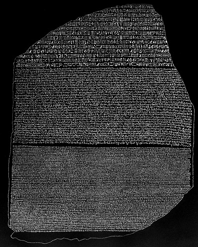 The Rosetta Stone, engraved in 196 BC and discovered in 1799 AD, with the same text in three versions: Hieroglyphics (above), Demotic, (middle), Greek (below)