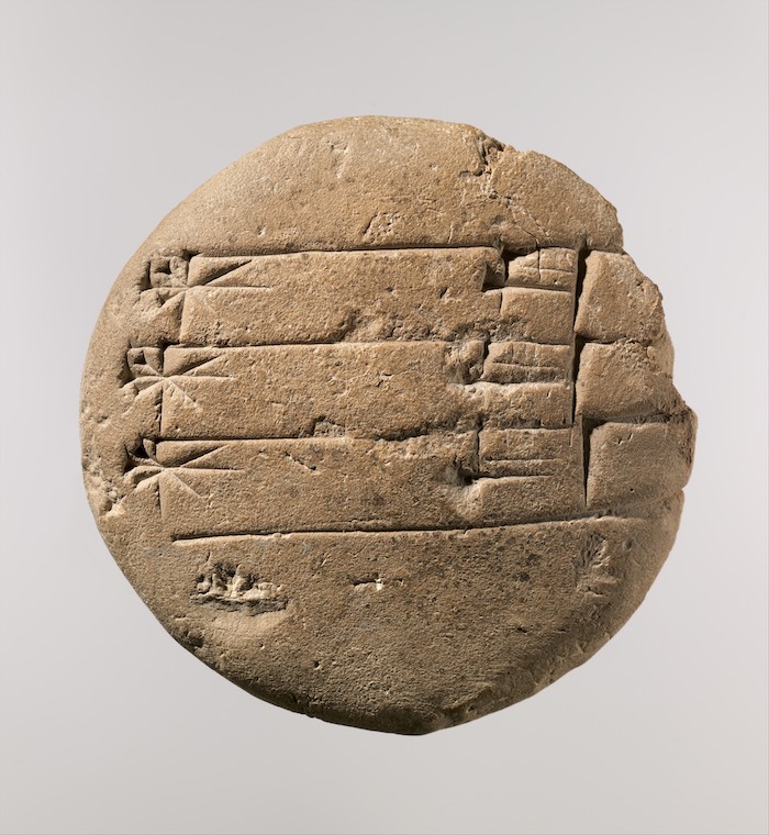 Old Babylonian lenticular clay tablet with a student exercise about a divine name, c. 20th-16th century BC. The Metropolitan Museum of Art, New York (ME 86.11.251).